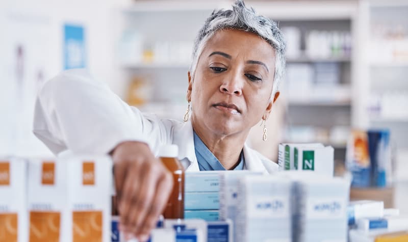 pharmacist-woman-shelf-and-packing-box-for-stock-2023-11-27-05-09-05-utc (1)